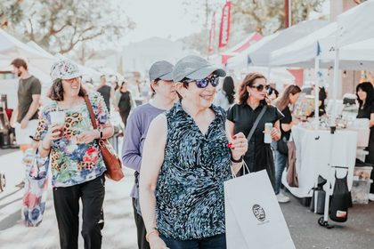 Couple browsing handmade goods on a mid-afternoon stroll through a Dreamers Markets pop-up