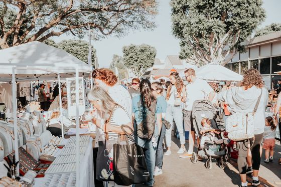 Crowd at a jewelry booth with stroller