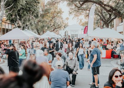 Crowd at a Dreamers Markets pop-up market in golden afternoon light